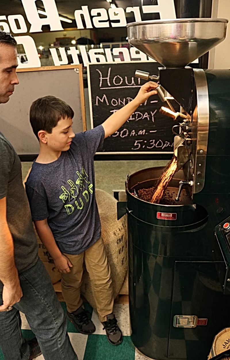 father-and-son-setting-up-commercial-coffee-roaster-machine